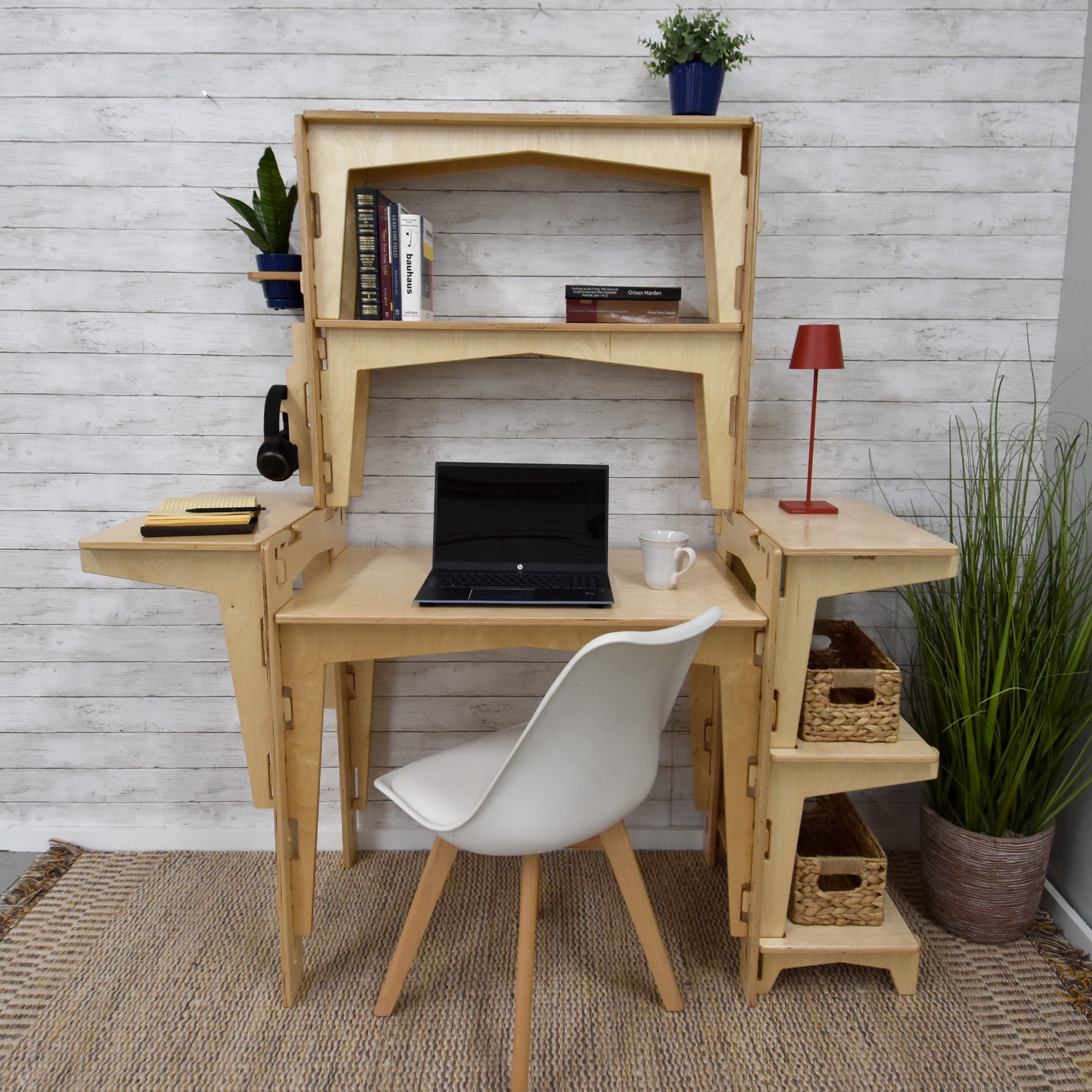 A sustainable MOD5 PRO Adjustable Modular Desk/Kitchen Hutch by FiVO, made of FSC-certified wood, with a laptop and lamp.