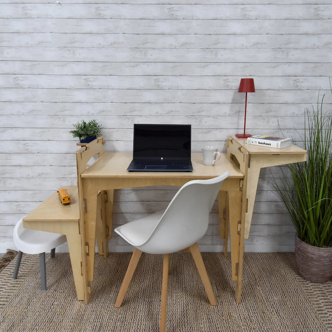 A sustainable MOD5 Adjustable Modular Desk with Two Shelves by FiVO, made of FSC-certified wood, with the shelves adjusted to suit both kids and adults.