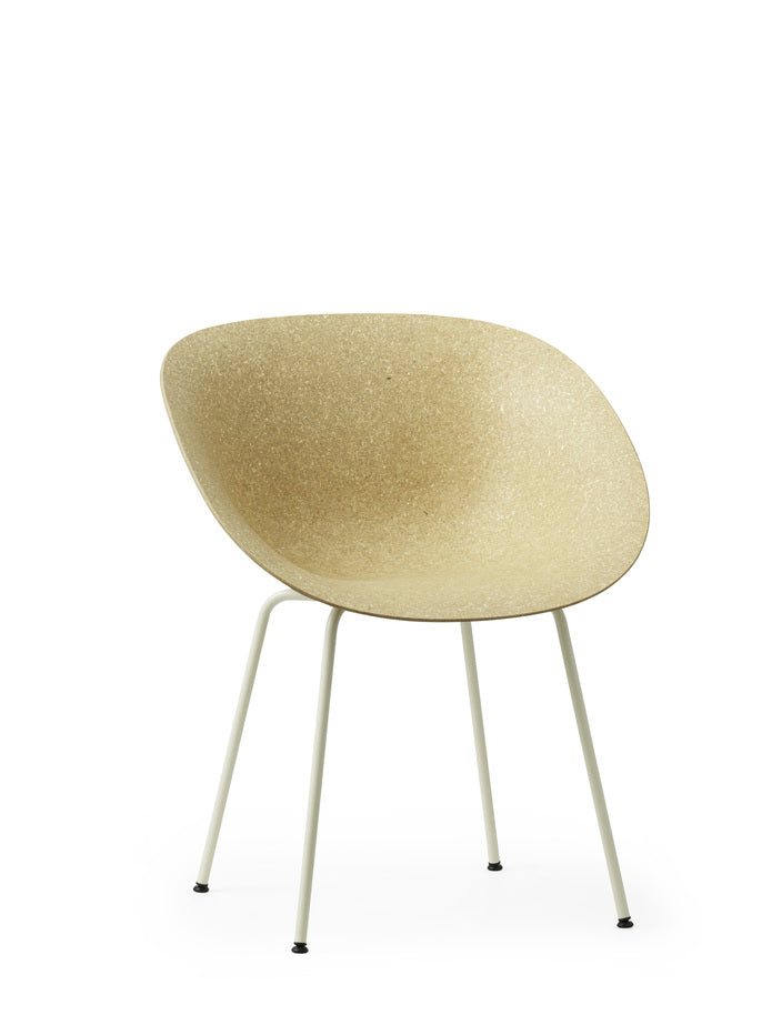 A renewable Mat Armchair made with hemp plants by Normann Copenhagen, with white-coated legs, side-angle view.