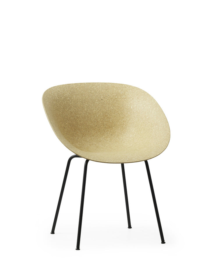 A renewable Mat Armchair made with hemp plants by Normann Copenhagen, with black-coated legs, side-angle view.