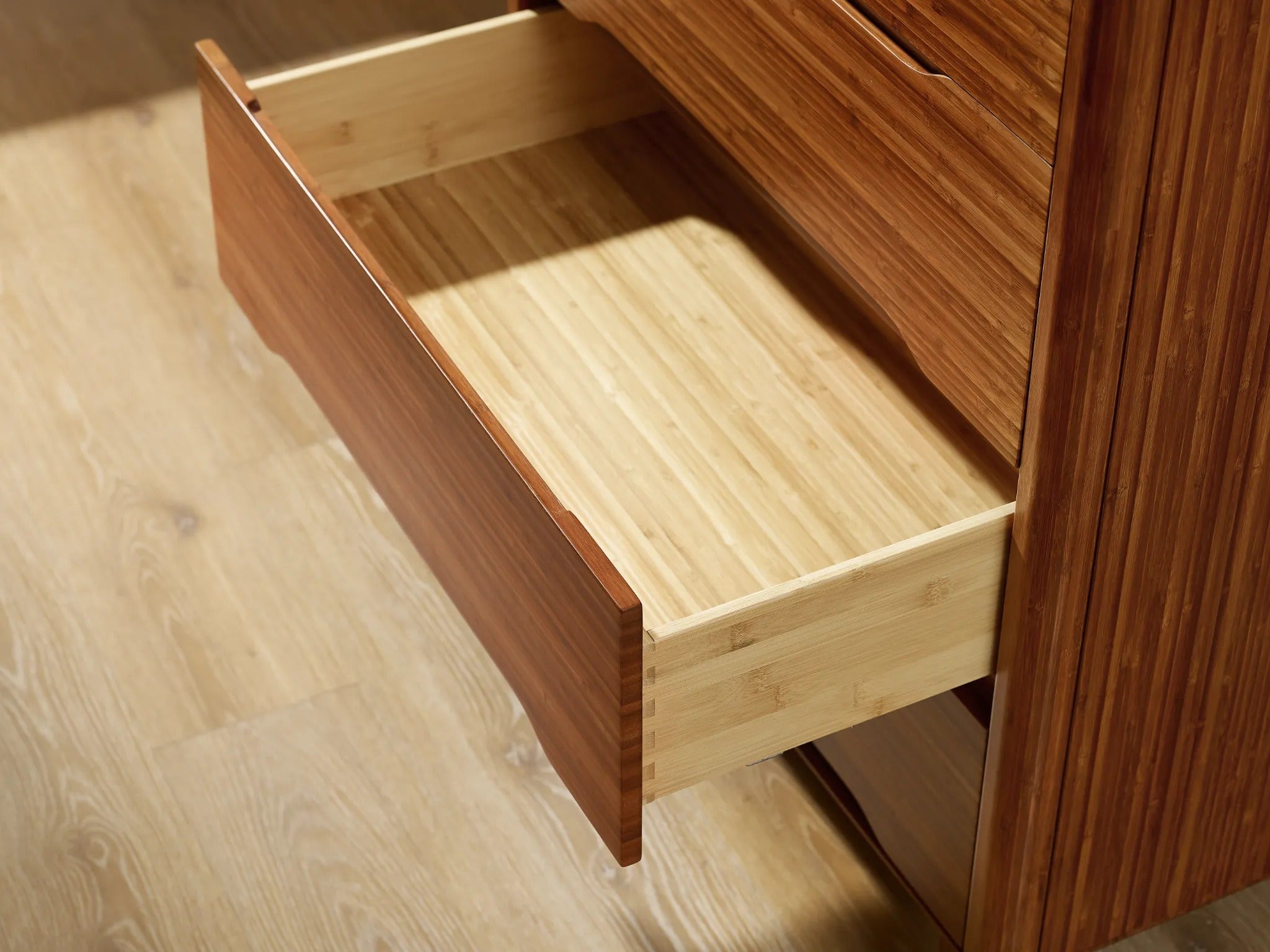 The drawer of the renewable Currant Bamboo High Dresser by Greenington, in amber color.