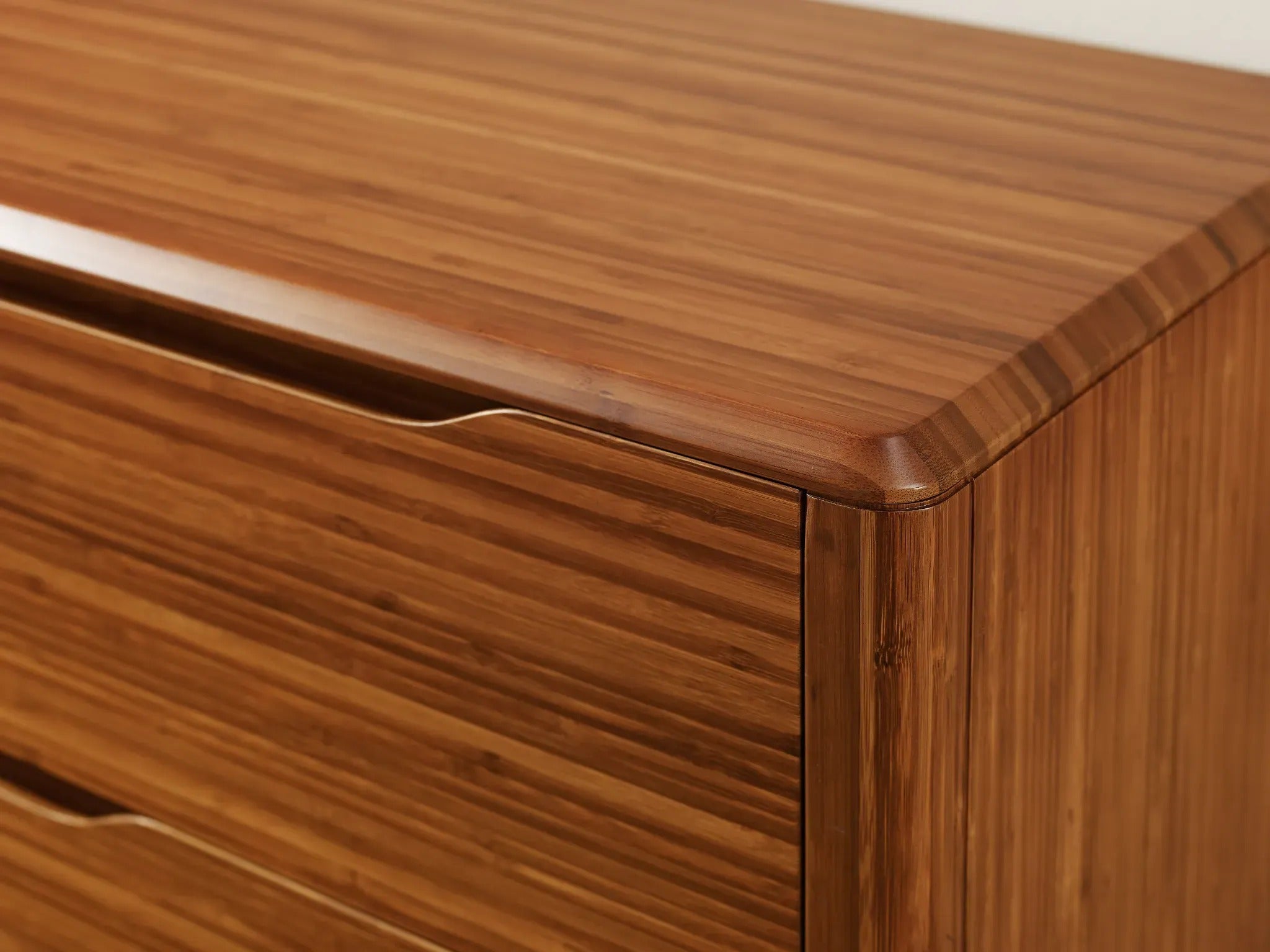 The close-up detail of the renewable Currant Bamboo Low Dresser by Greenington, in amber color.