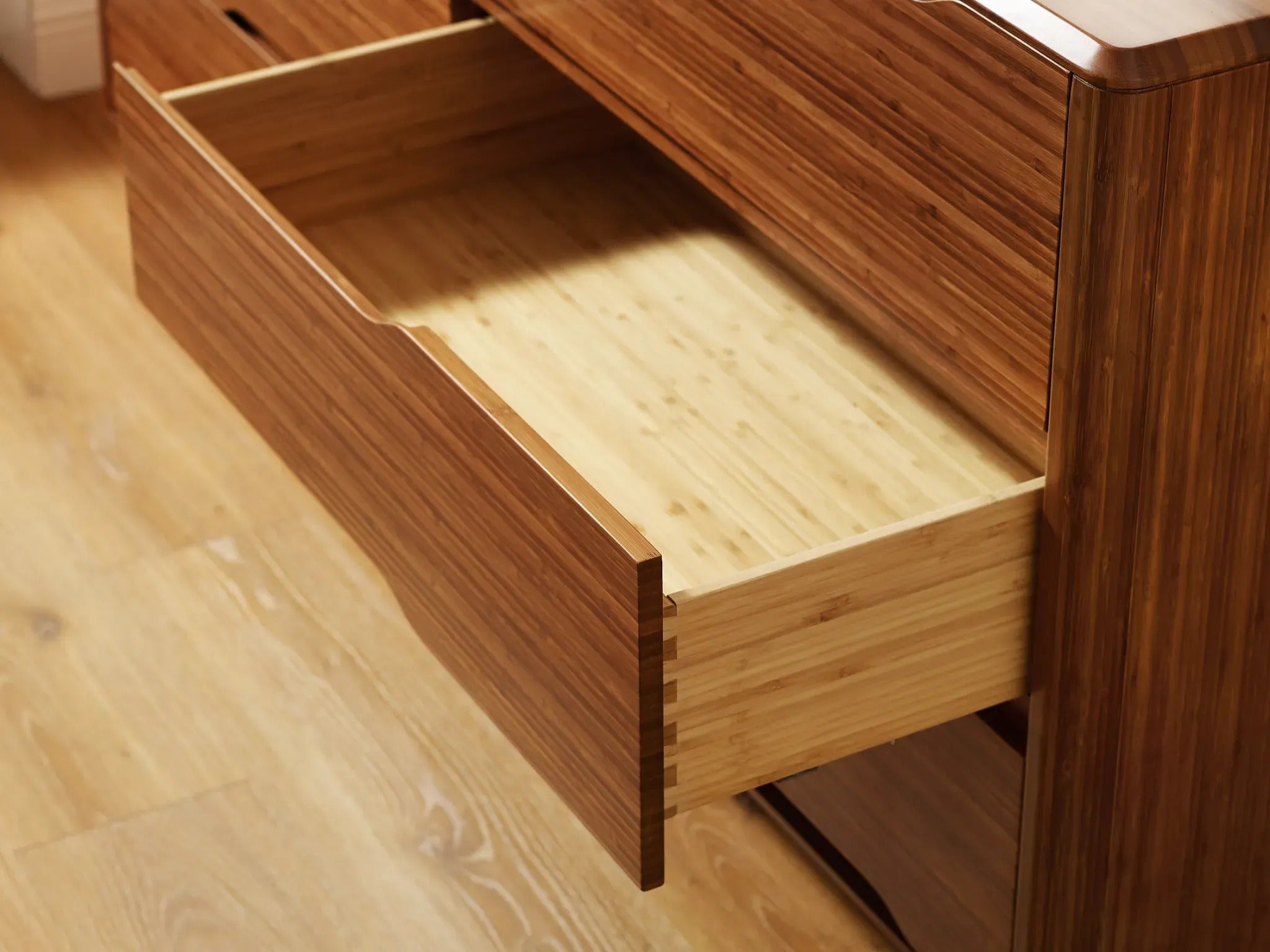 The drawer of the renewable Currant Bamboo Low Dresser by Greenington, in amber color.