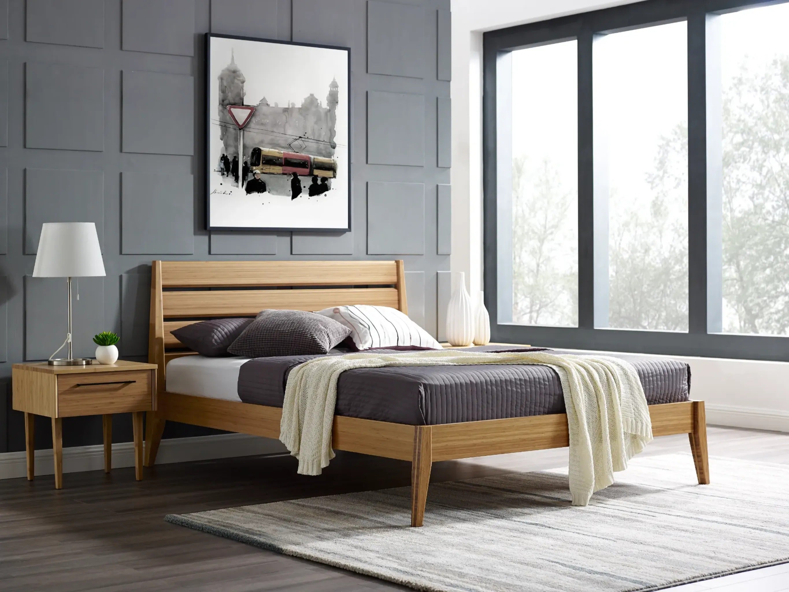 A sustainable Sienna Bamboo Bedframe by Greenington, placed in a bedroom with a nightstand next to it.