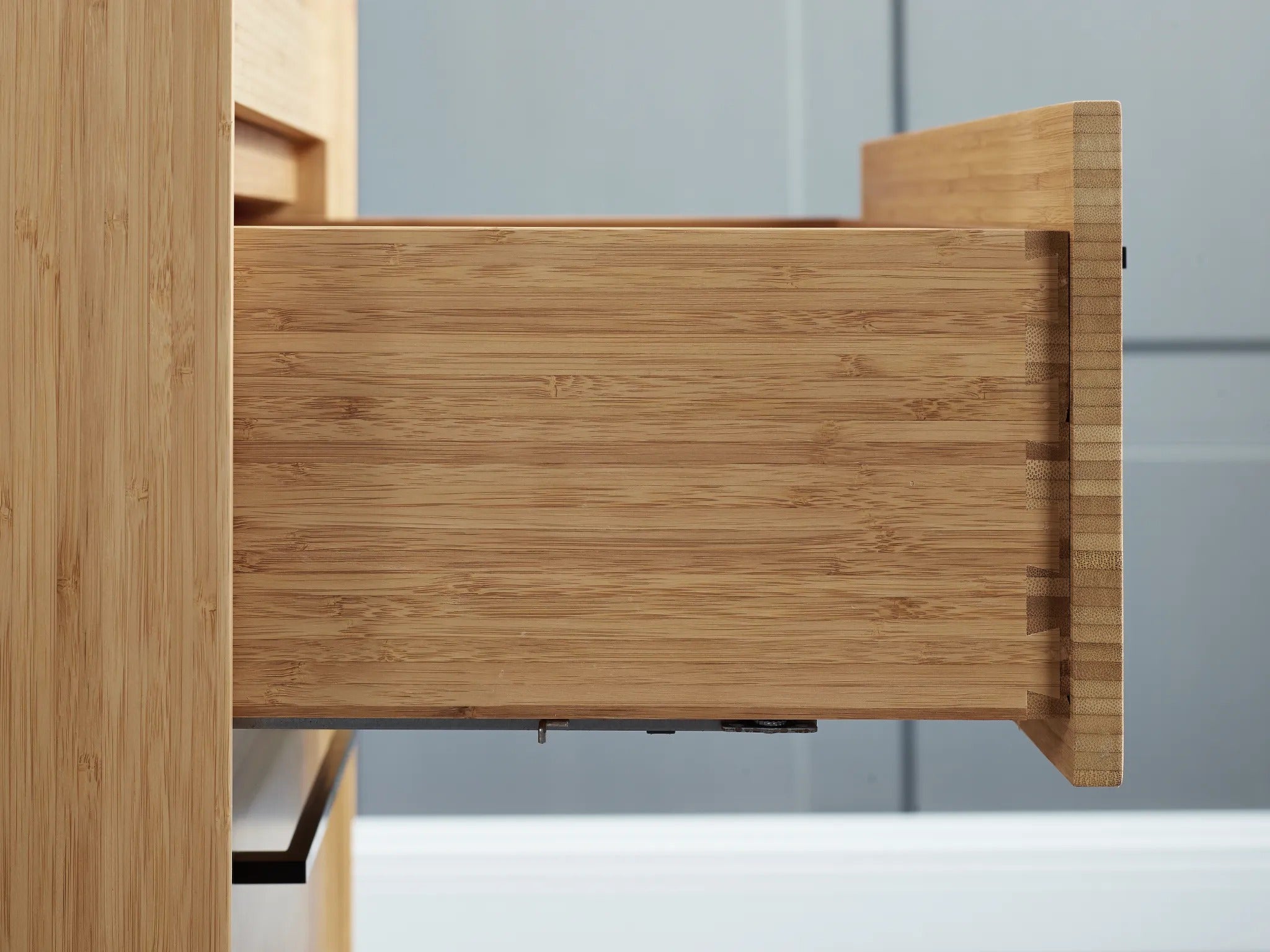 The drawer of the renewable Sienna Bamboo High Dresser by Greenington, side view.