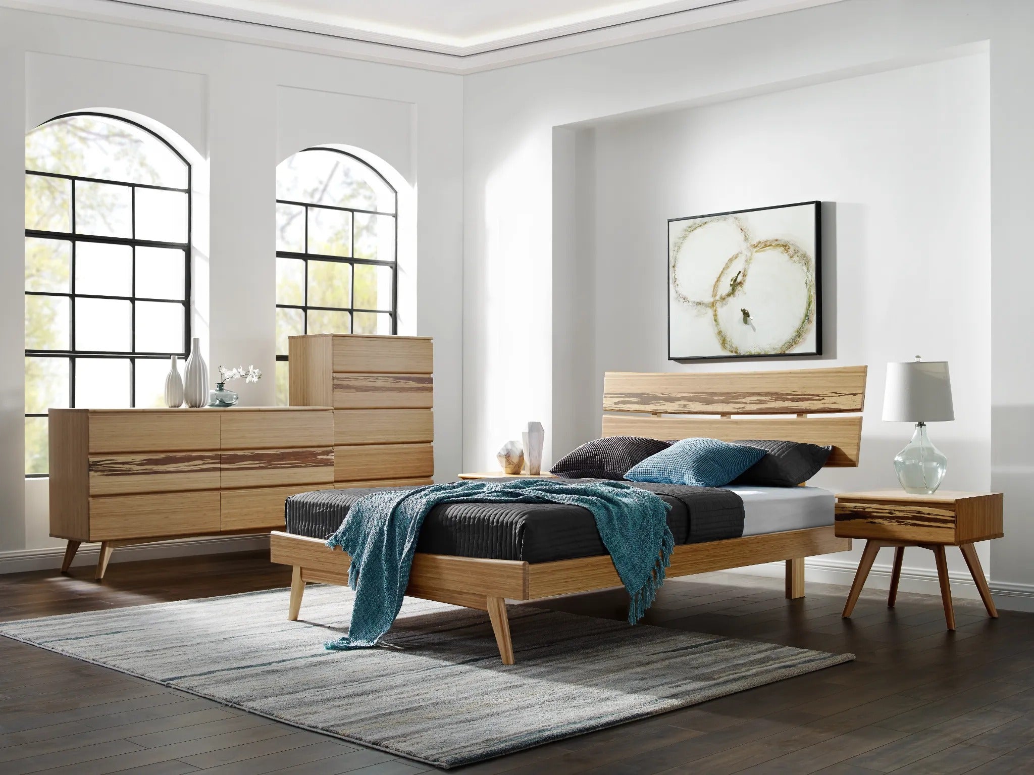 A sustainable Azara Bamboo Low Dresser by Greenington, in caramel color, situated in a bedroom alongside a bed and a high dresser.