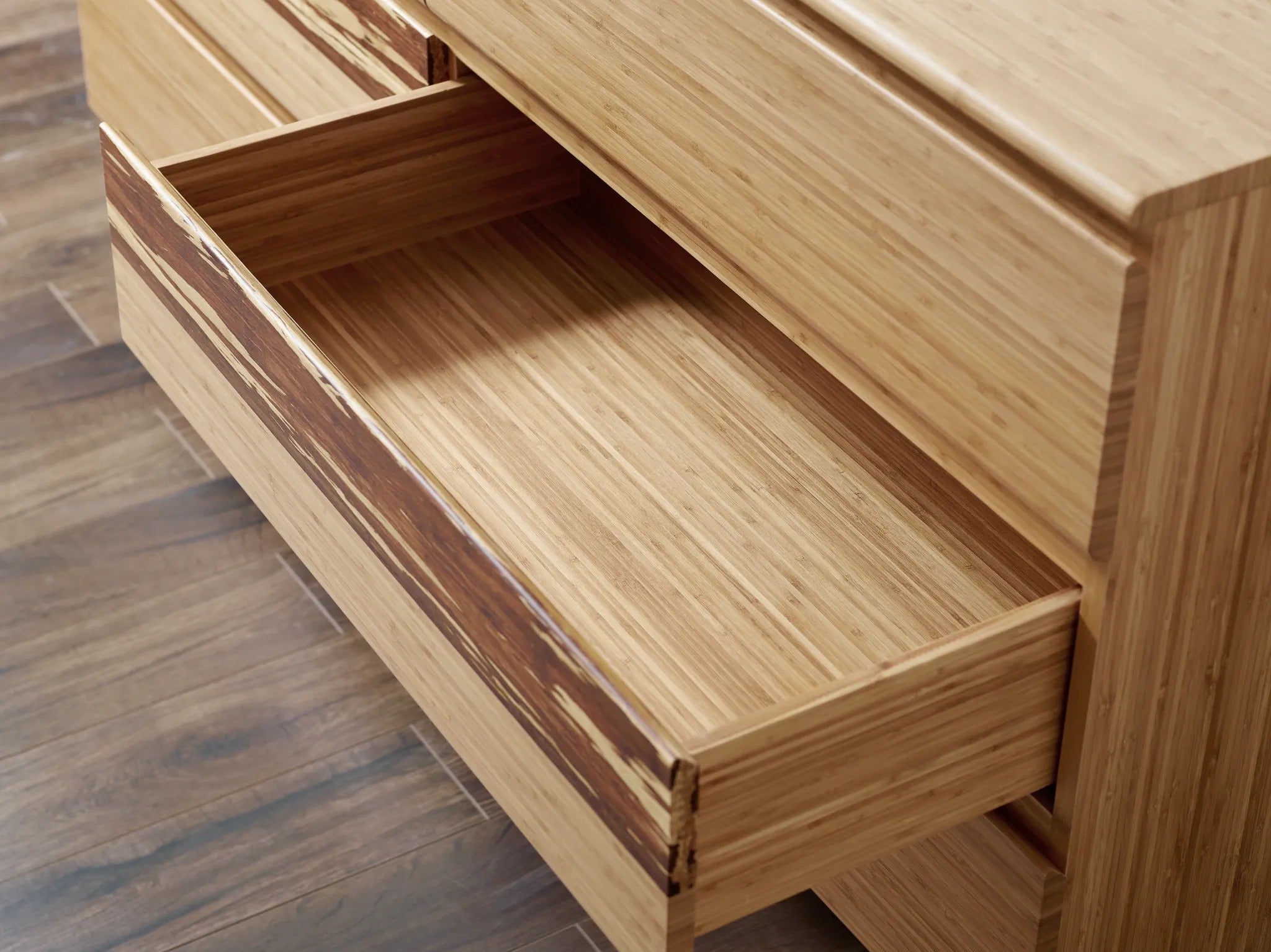 The drawer of a sustainable Azara Bamboo Low Dresser by Greenington, in caramel color.
