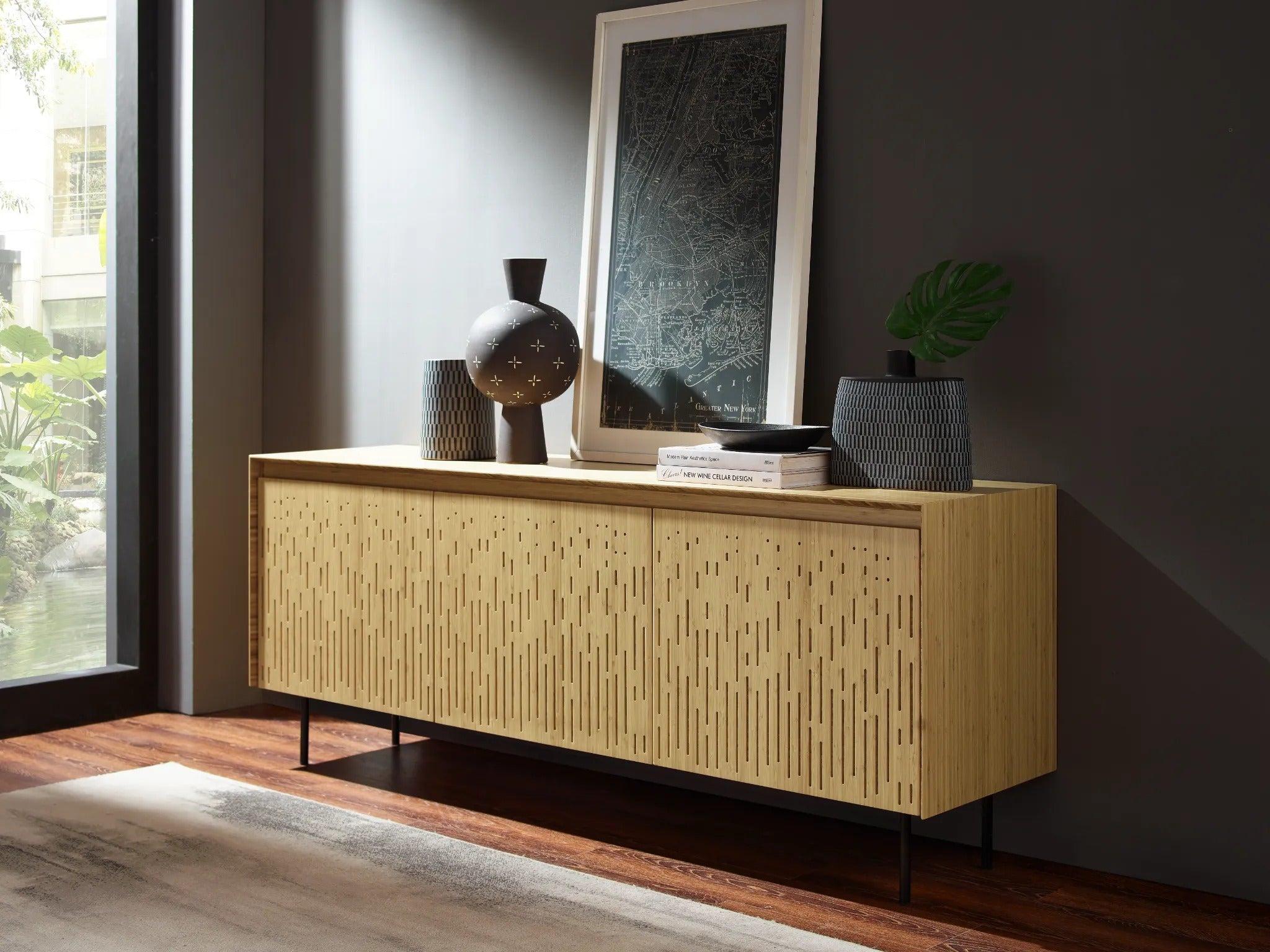 A sustainable Hanna Bamboo Sideboard by Greenington, with vases and an elegant art work, side angel view.