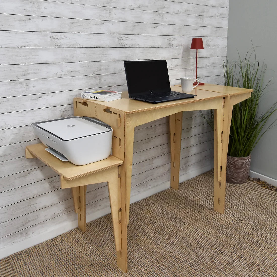 The sustainable MOD5 Adjustable Modular Desk with Two Shelves by FiVO, made of FSC-certified wood, features one shelf adjusted to hold a printer, while the main table supports a laptop.