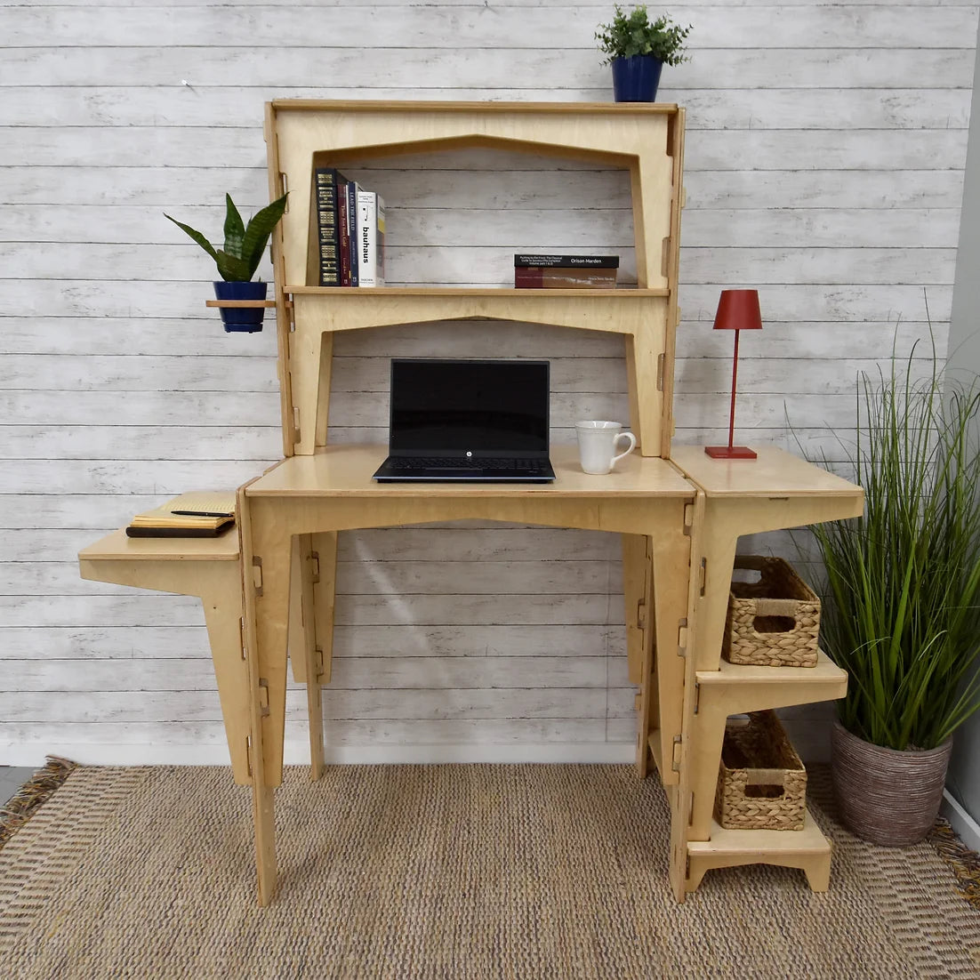 A sustainable MOD5 PRO Adjustable Modular Desk/Kitchen Hutch by FiVO, made of FSC-certified wood, with a laptop and lamp.