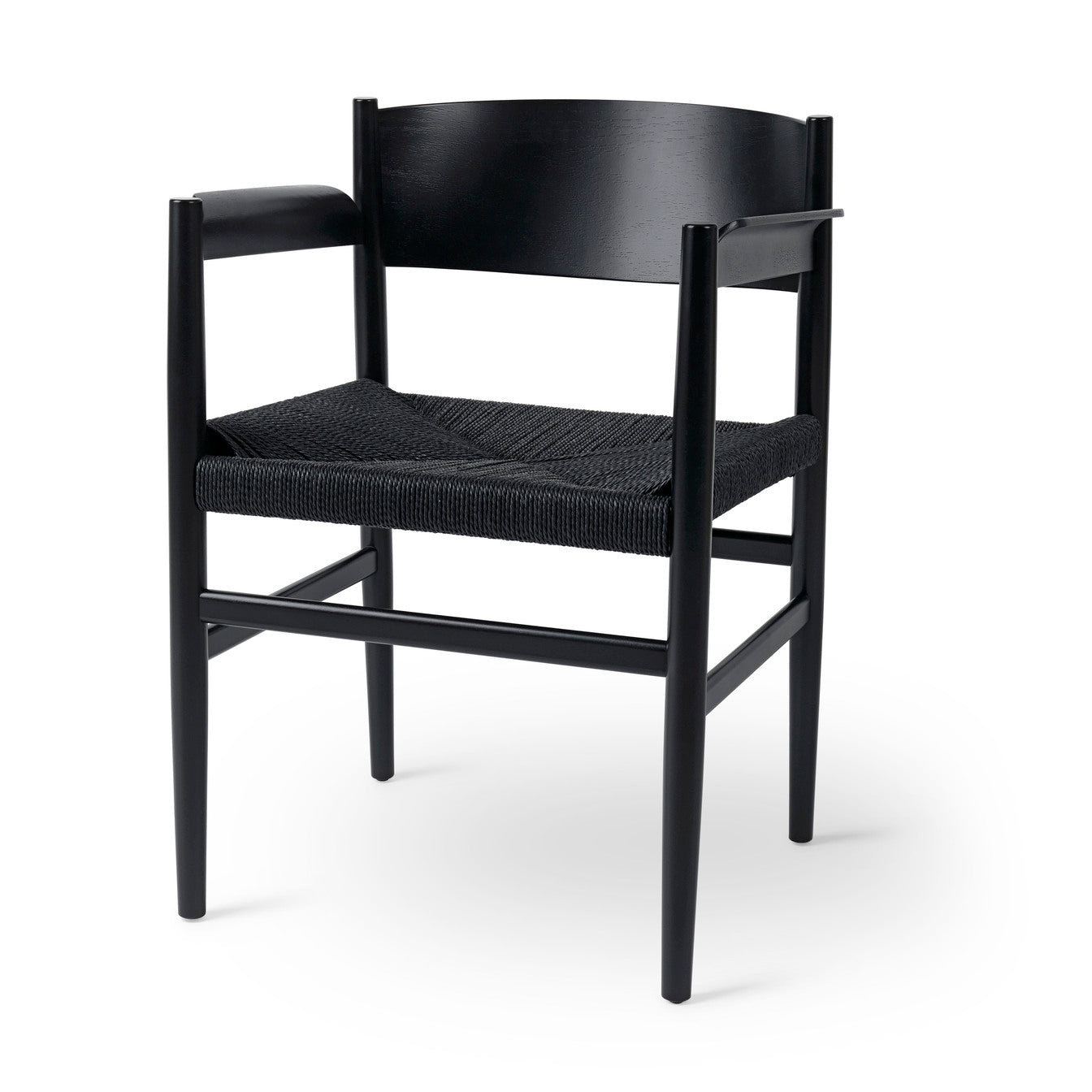 An eco-friendly Nestor Armchair made of FSC-certified wood by Mater, in black.