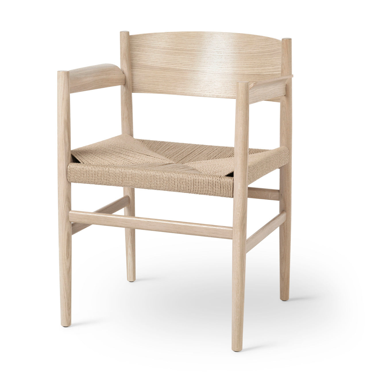 A sustainable dining armchair, made of FSC-certified wood and papercord, by Mater, in oak matte natural.