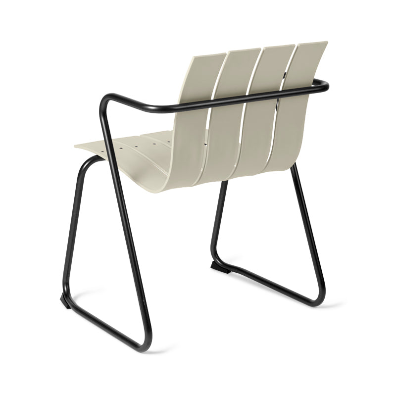 An Ocean Chair made of recycled plastic by Mater, in sand color, back view.