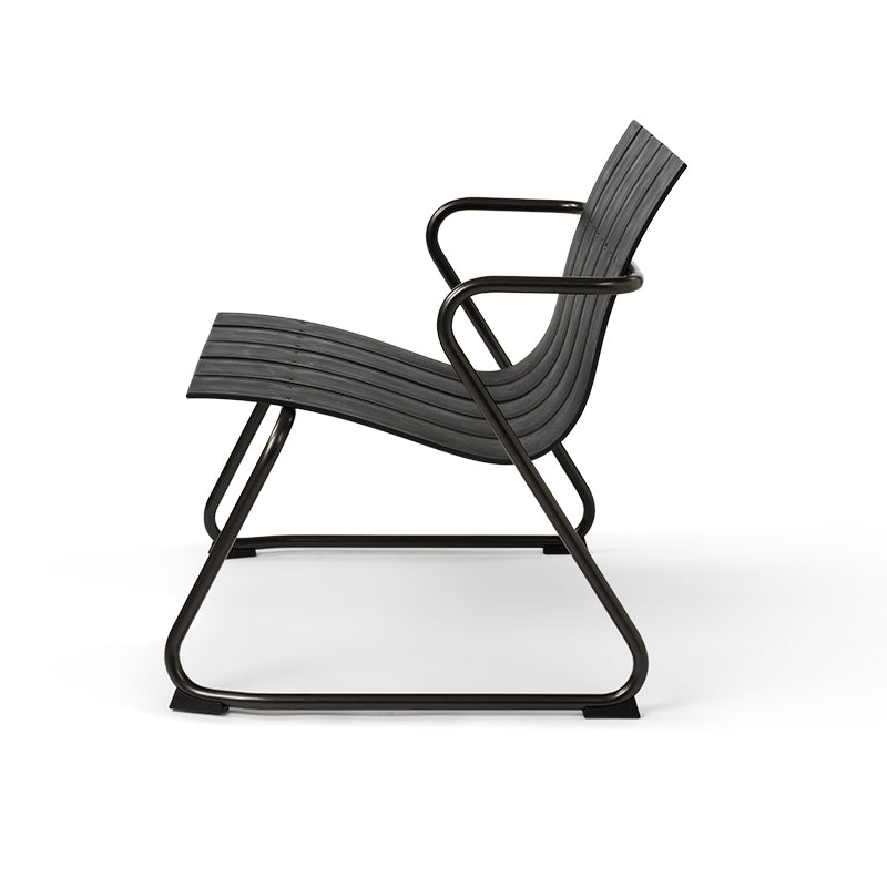 An Ocean Lounge Chair made of recycled plastic by Mater, in black, side view.