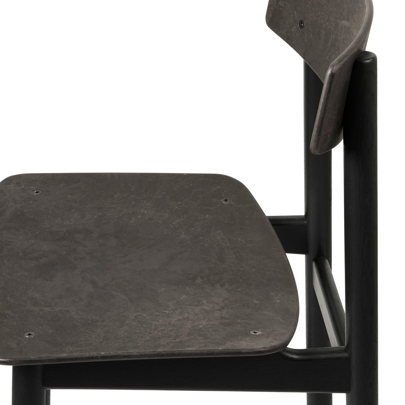 The detail of the black Conscious chair made with recycled material, by Mater.