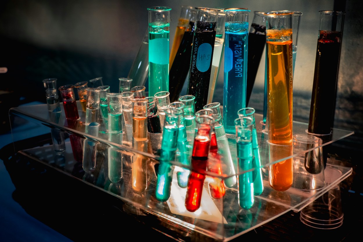 Chemical test tubes in multiple colors, representing toxic substances.