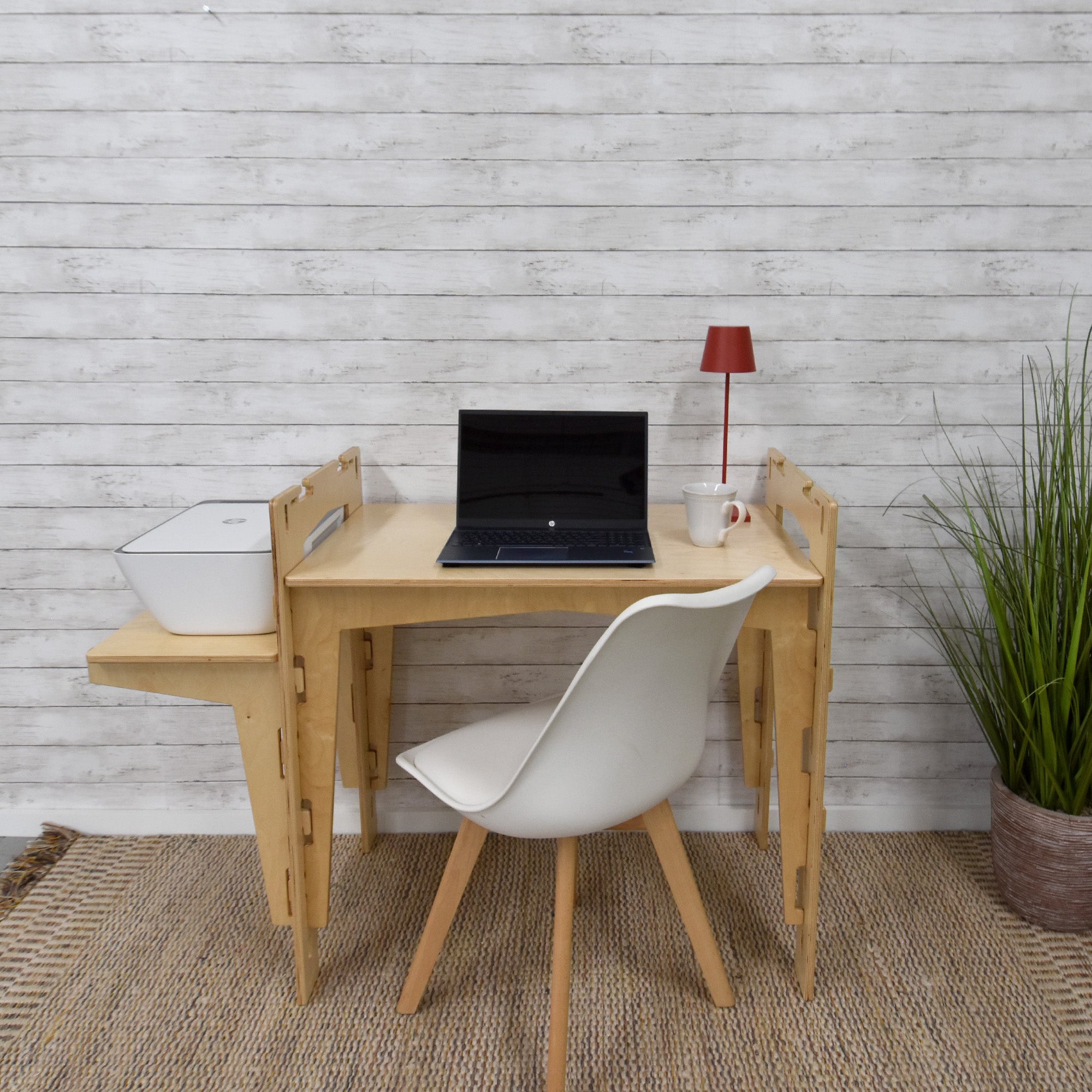 A handcrafted MOD5 Adjustable Modular Desk made of FSC-certified wood by FiVO, with the extension leaf and the main table adjusted to a lower position.