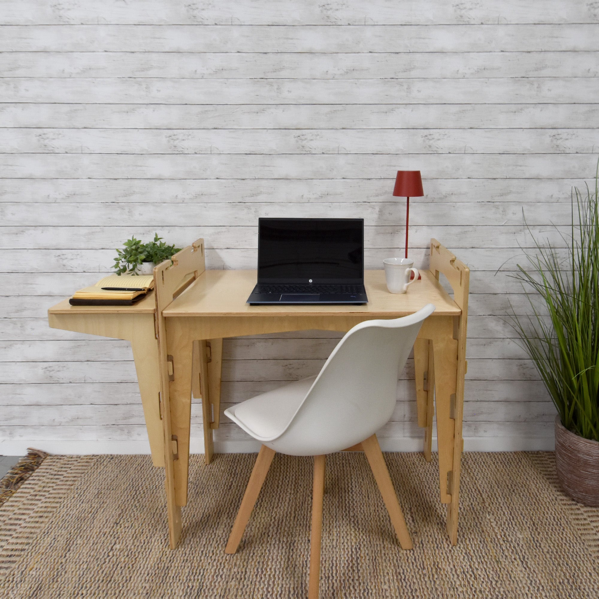 A handcrafted MOD5 Adjustable Modular Desk made of FSC-certified wood by FiVO, with the extension leaf adjusted to the same level as the main table.