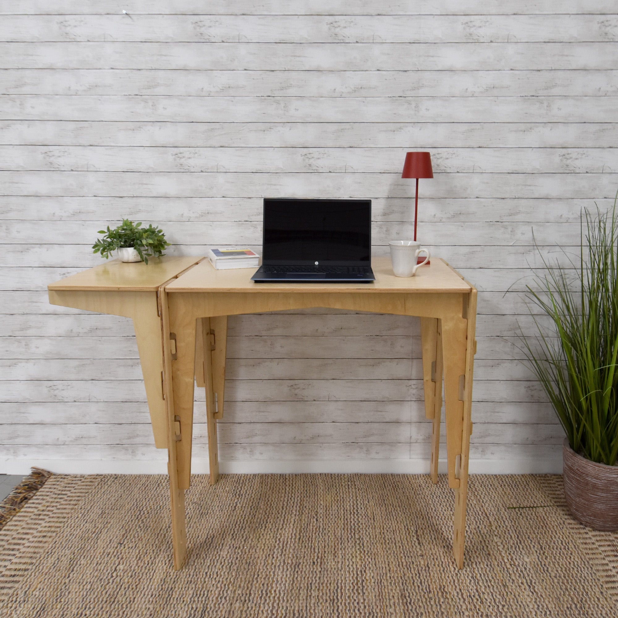 A handcrafted MOD5 Adjustable Modular Desk made of FSC-certified wood by FiVO, with the extension leaf adjusted to the same level as the main table.