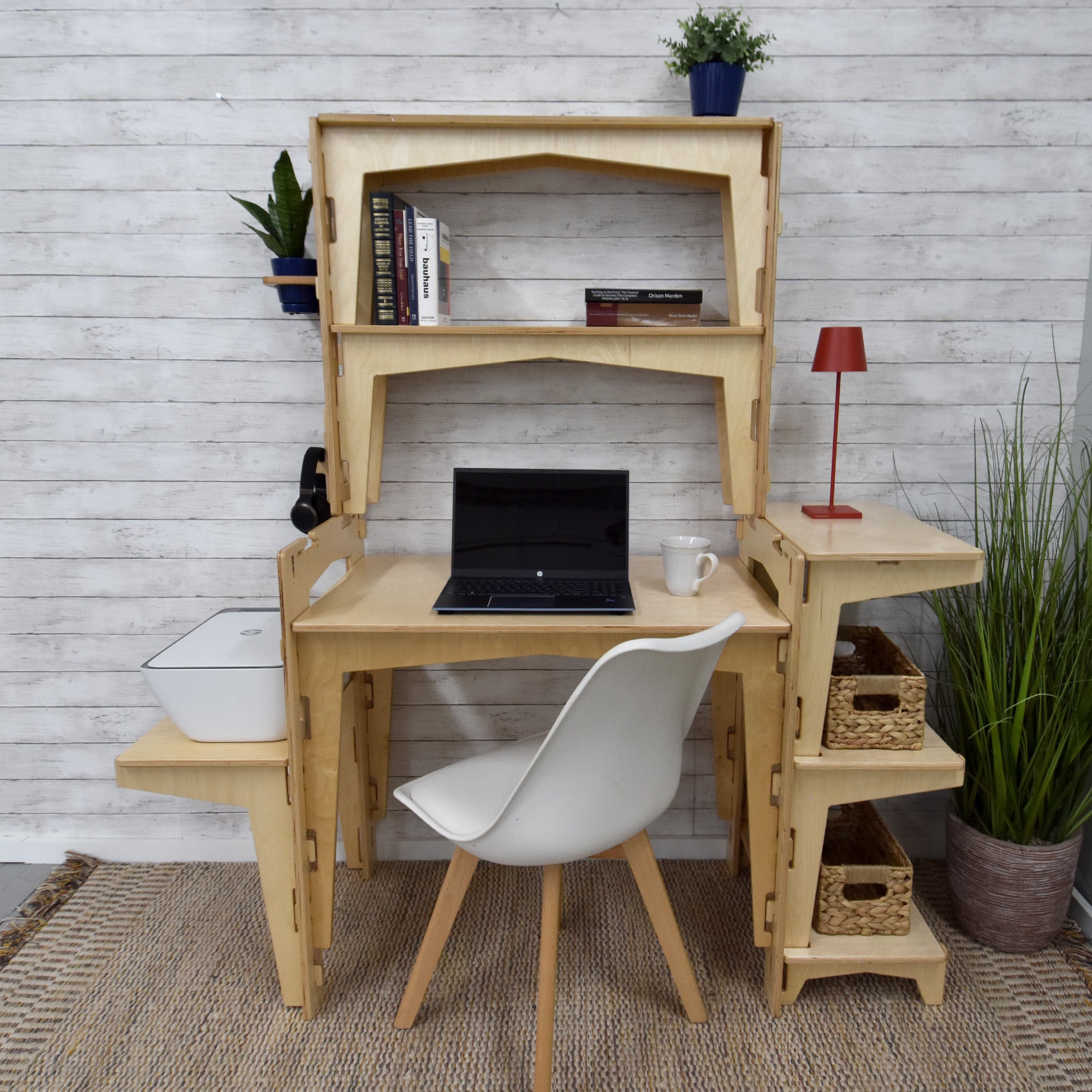 A sustainable MOD5 PRO Adjustable Modular Desk/Kitchen Hutch by FiVO, made of FSC-certified wood, with a laptop and lamp.
