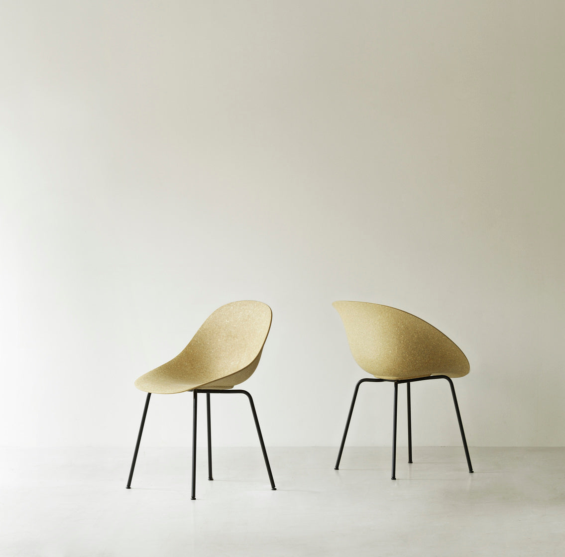 Two renewable Mat Armchairs made with hemp plants by Normann Copenhagen, with black-coated legs.