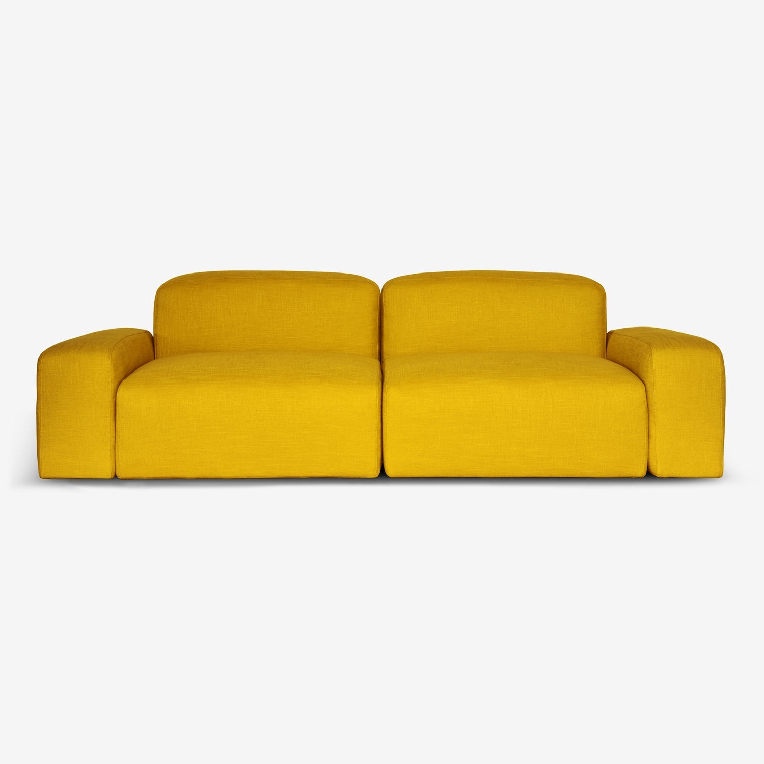 A living room with dramatic tall windows a sustainable sofa in yellow linen. Made with FSC-certified wood and organic latex , by Biosofa.