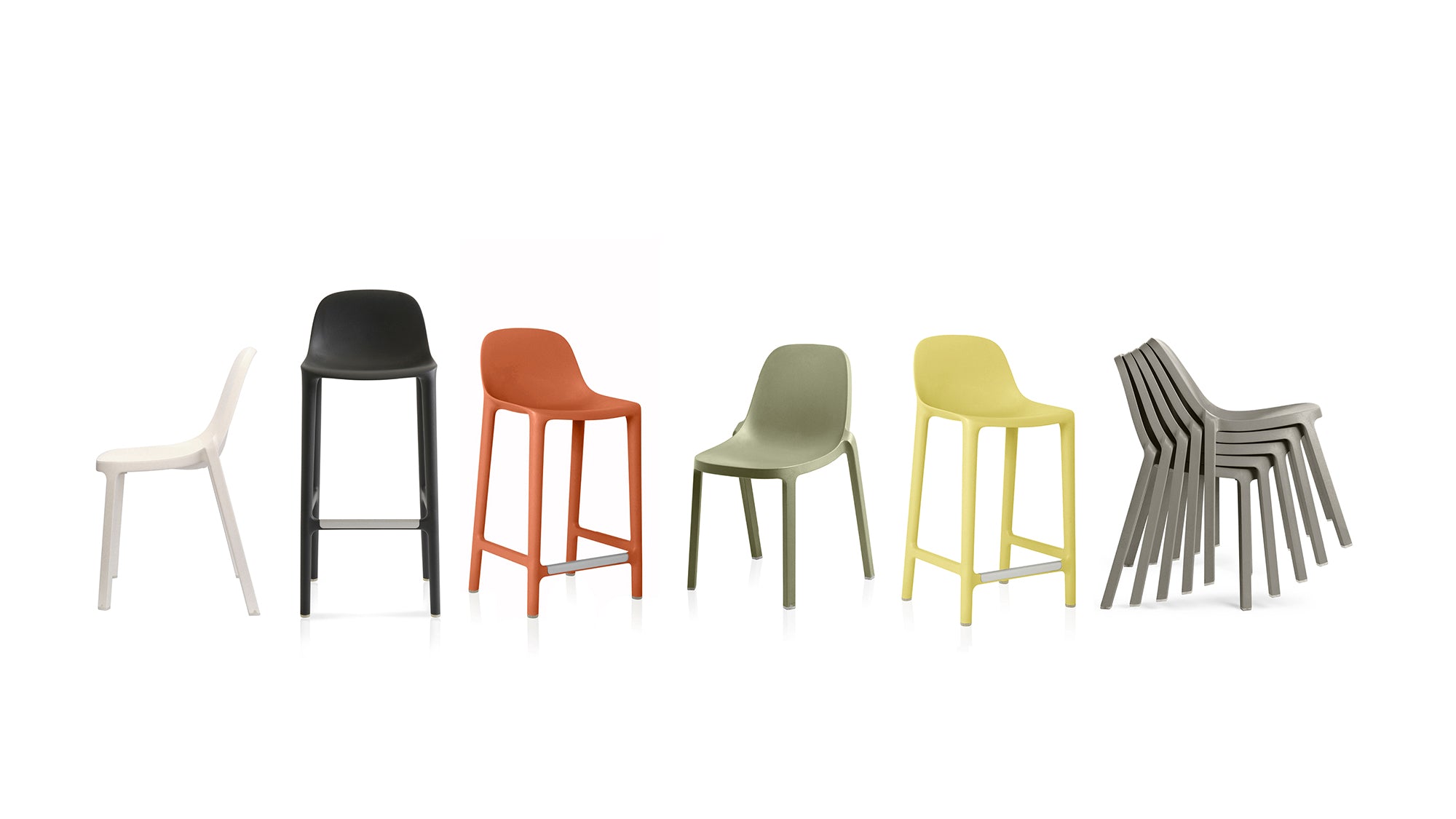 Six recycled plastic Broom Chairs by Emeco: yellow, dark grey, light grey, orange, white, and sage green.