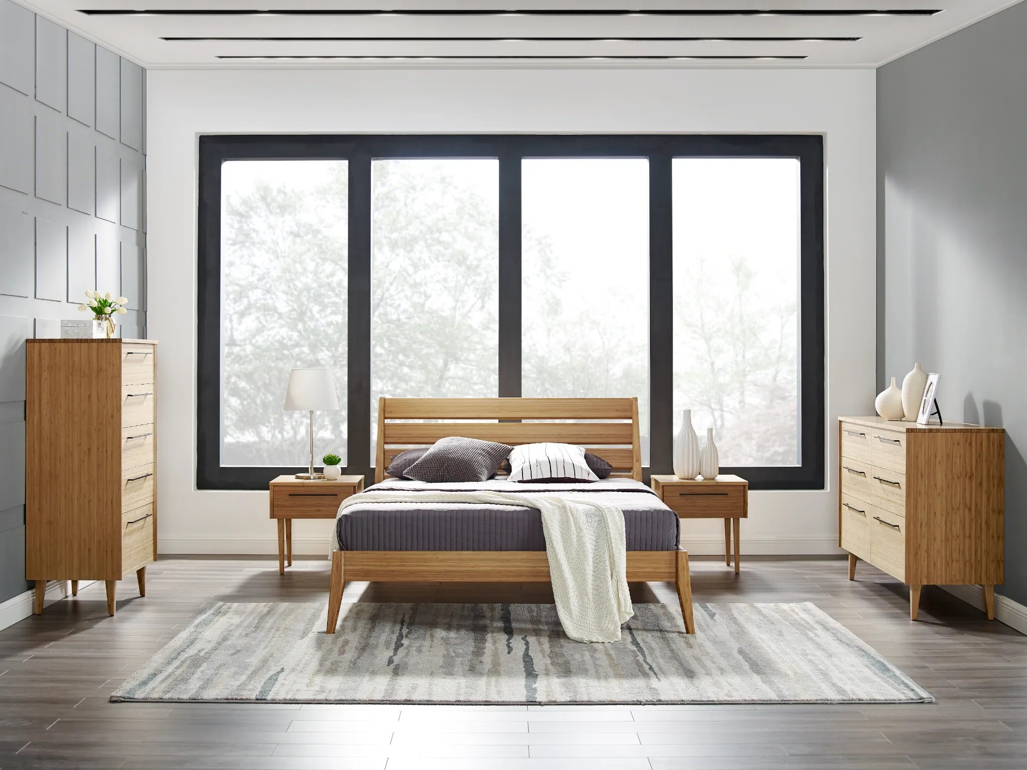 Two eco-friendly Sienna Bamboo Nightstands by Greenington, placed in a bedroom alongside a bed and a high and low dresser.