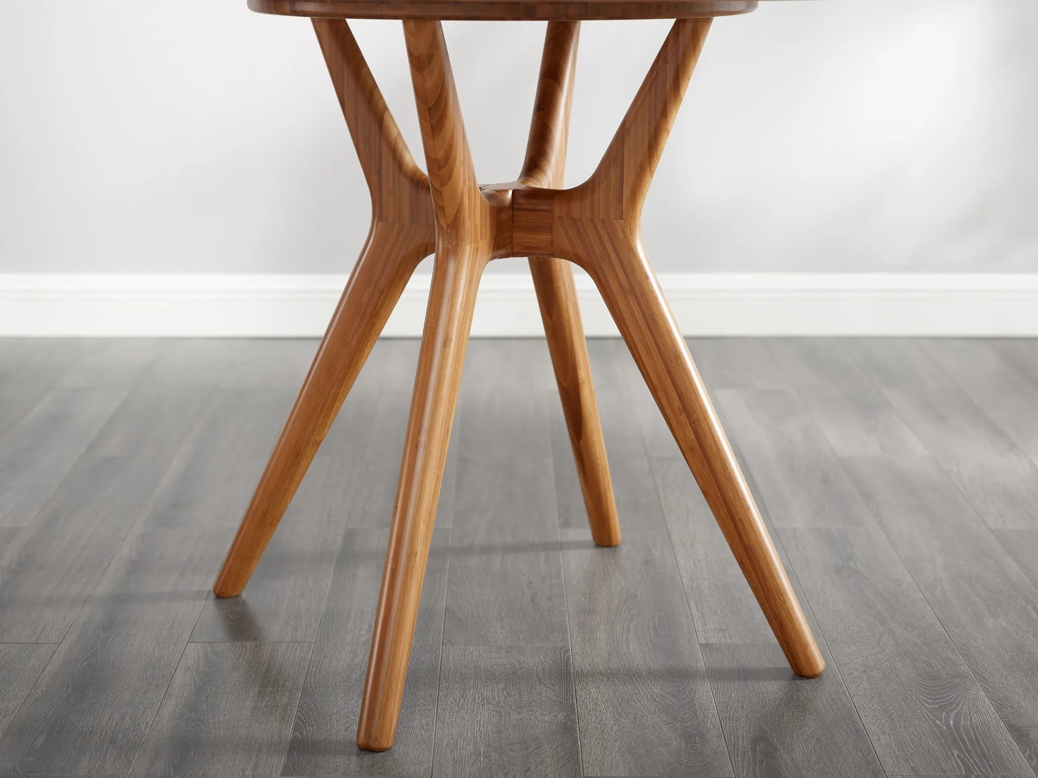 The leg detail of the eco-friendly Sitka Bamboo Dining Table by Greenington, in a wider view.