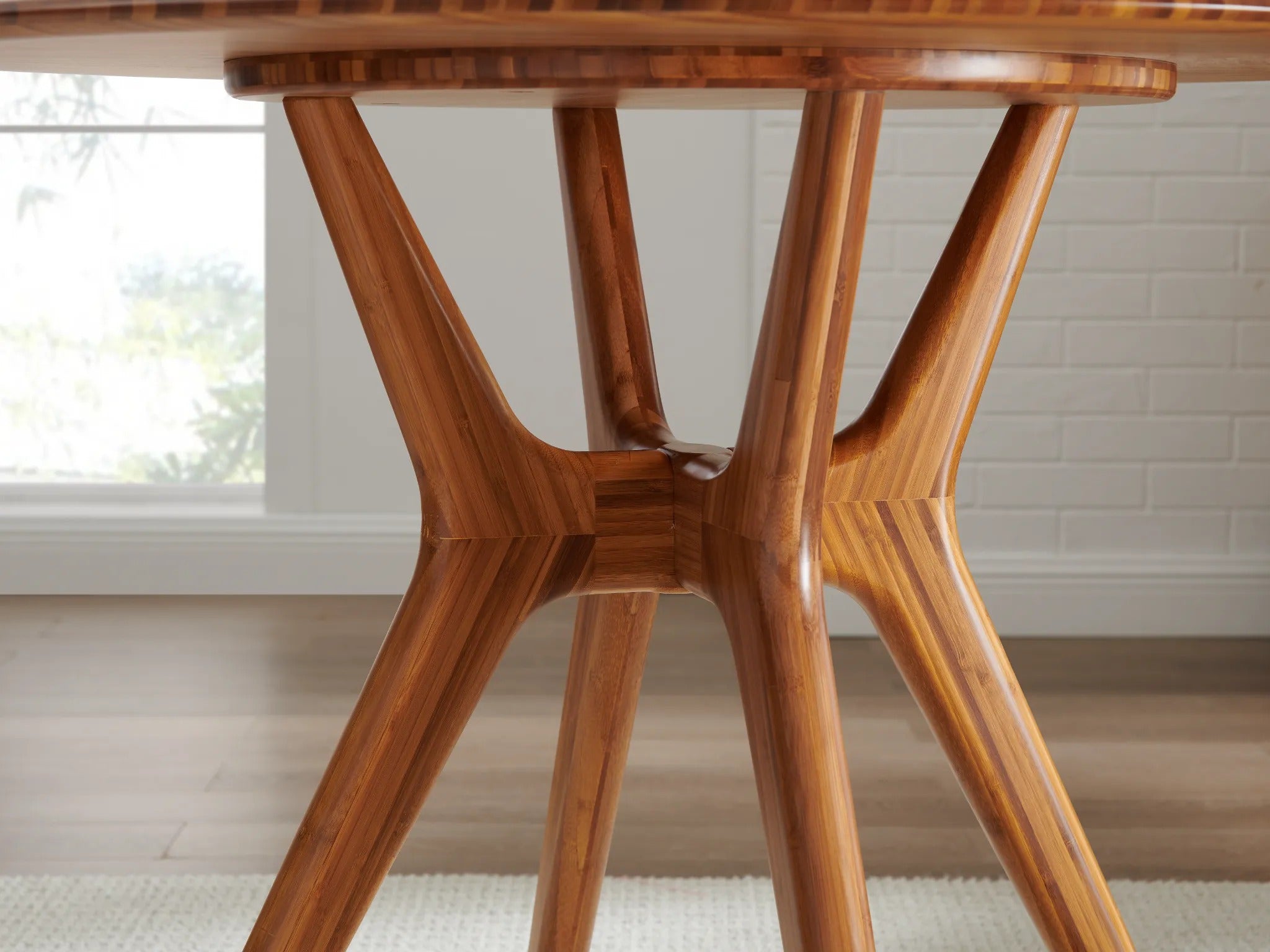 A close-up look at the legs of an eco-friendly Sitka Bamboo Dining Table by Greenington, in amber color.