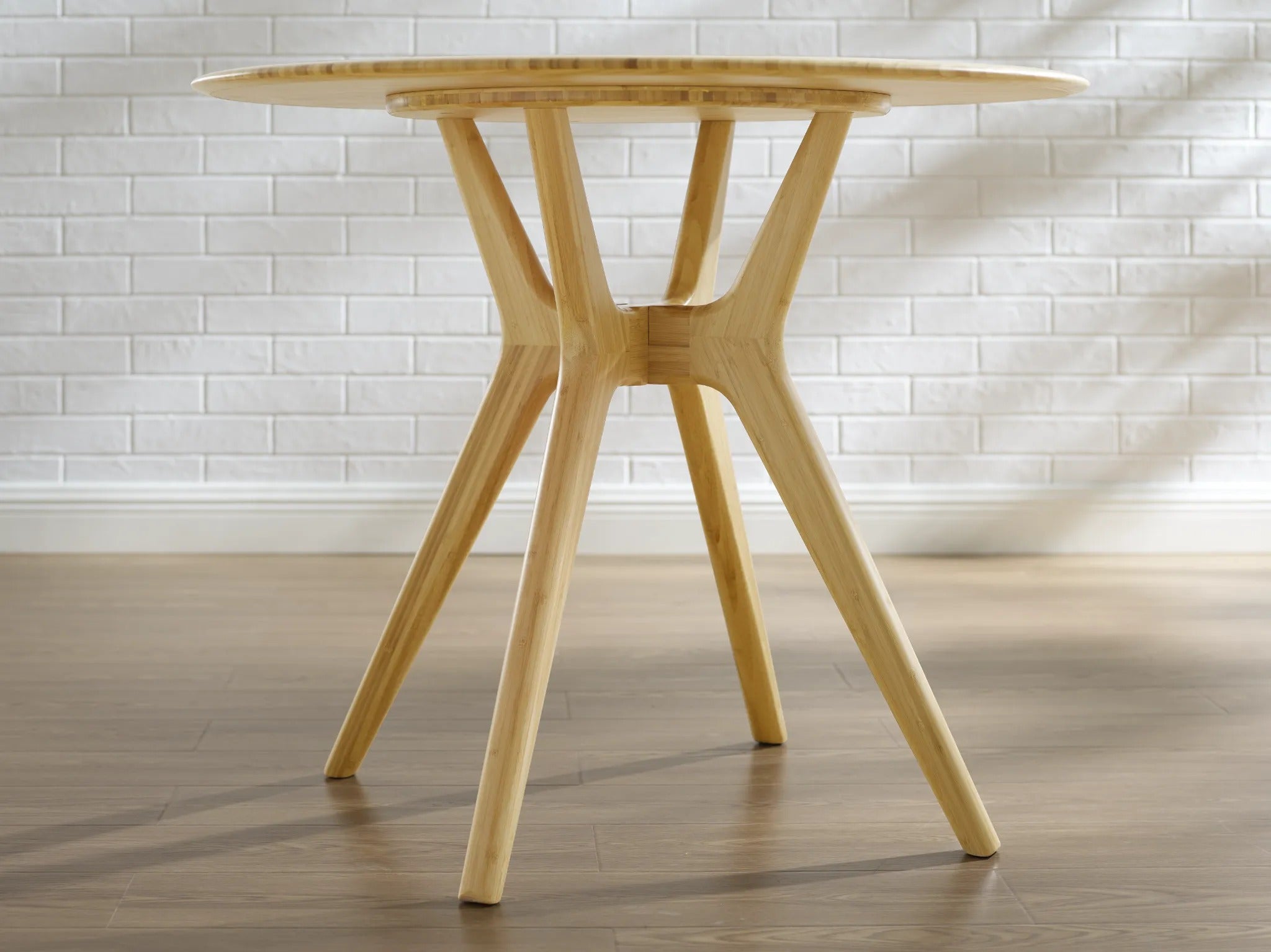 The leg detail of the eco-friendly Sitka Bamboo Dining Table by Greenington, in a wider view.