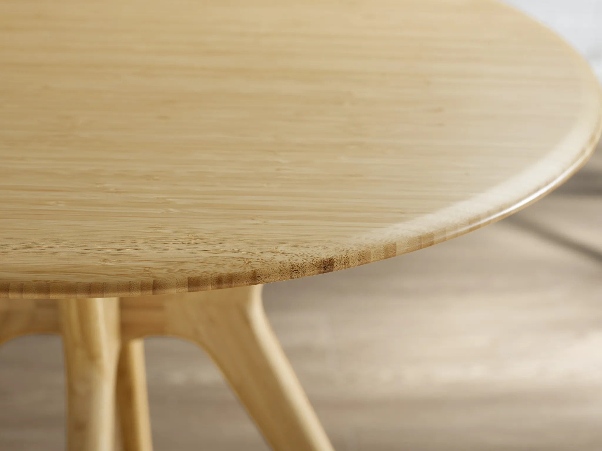 The edge of the round surface of the eco-friendly Sitka Bamboo Dining Table, by Greenington.
