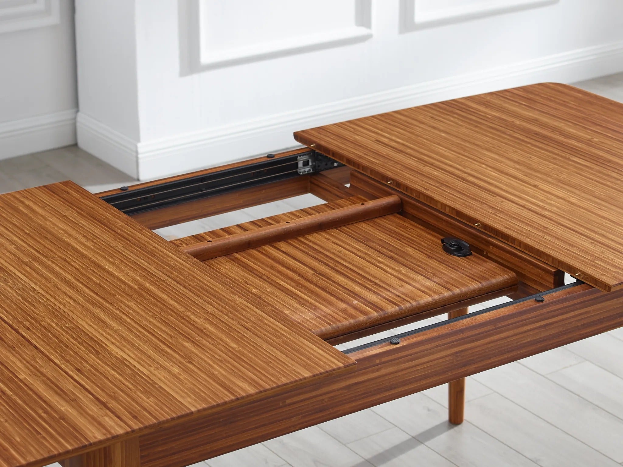The hidden extension of the sustainable Mija Extendable Dining Table, by Greenington.