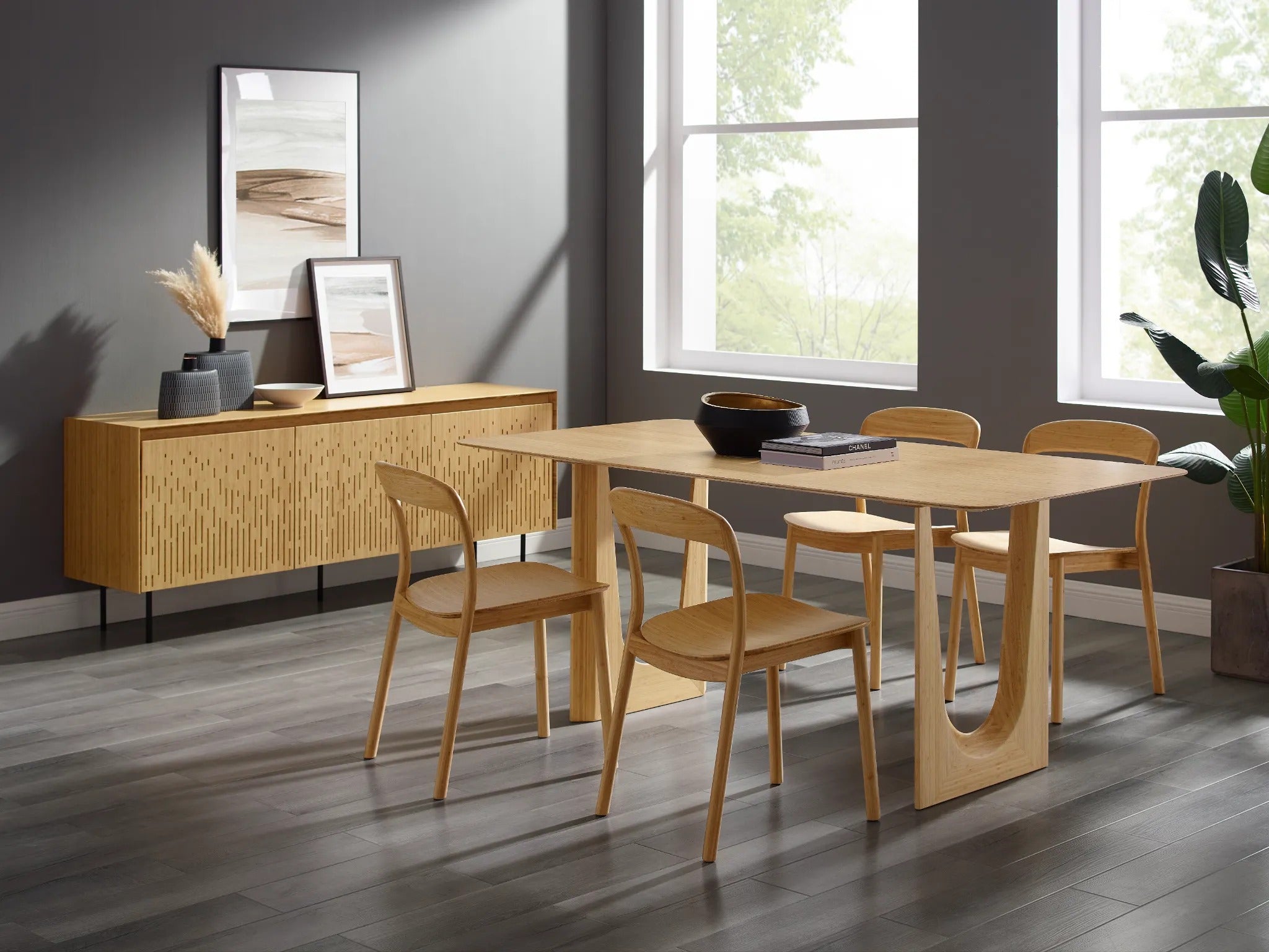 Four sustainable Hanna Bamboo Dining Chairs by Greenington, arranged around the dining table in a dining room.