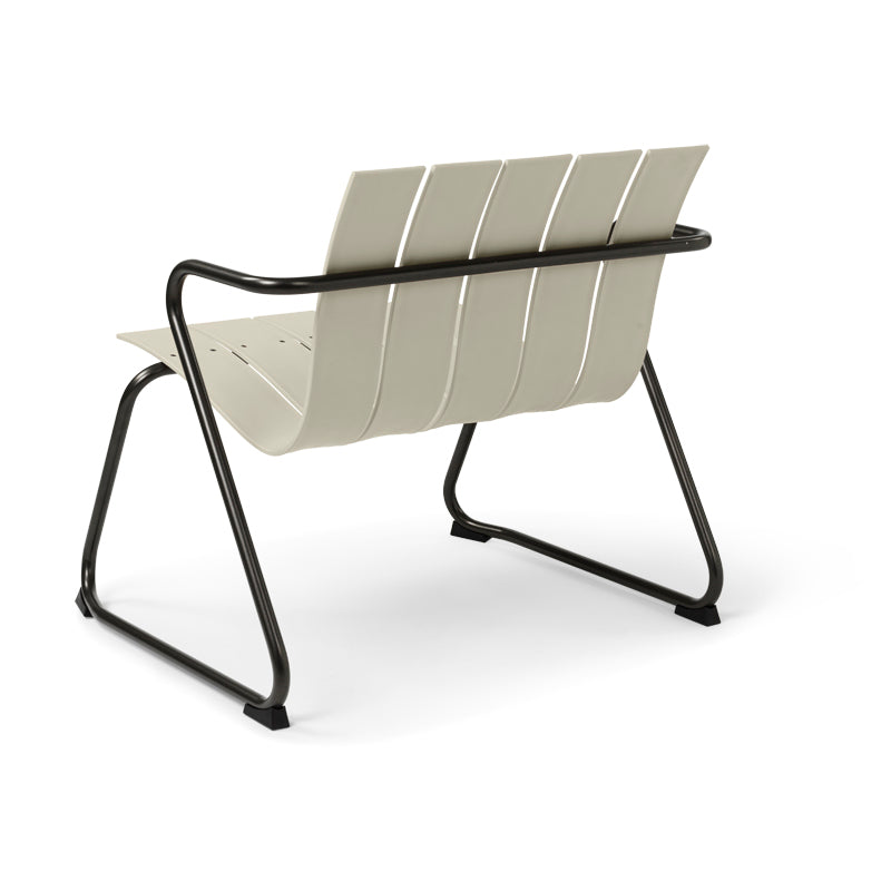 An Ocean Lounge Chair made of recycled materials by Mater, in sand color, back view.