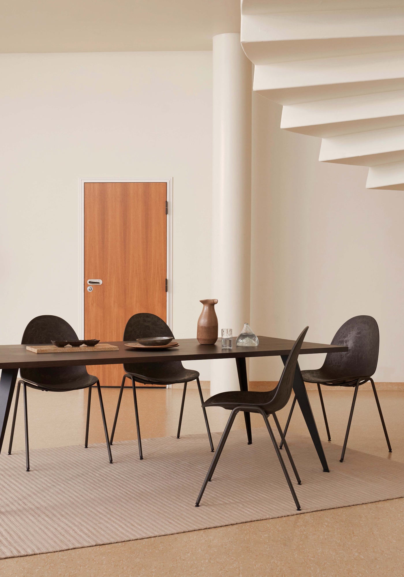A dining table with four eco-friendly Matek eternity chairs made with recycled material, by Mater.