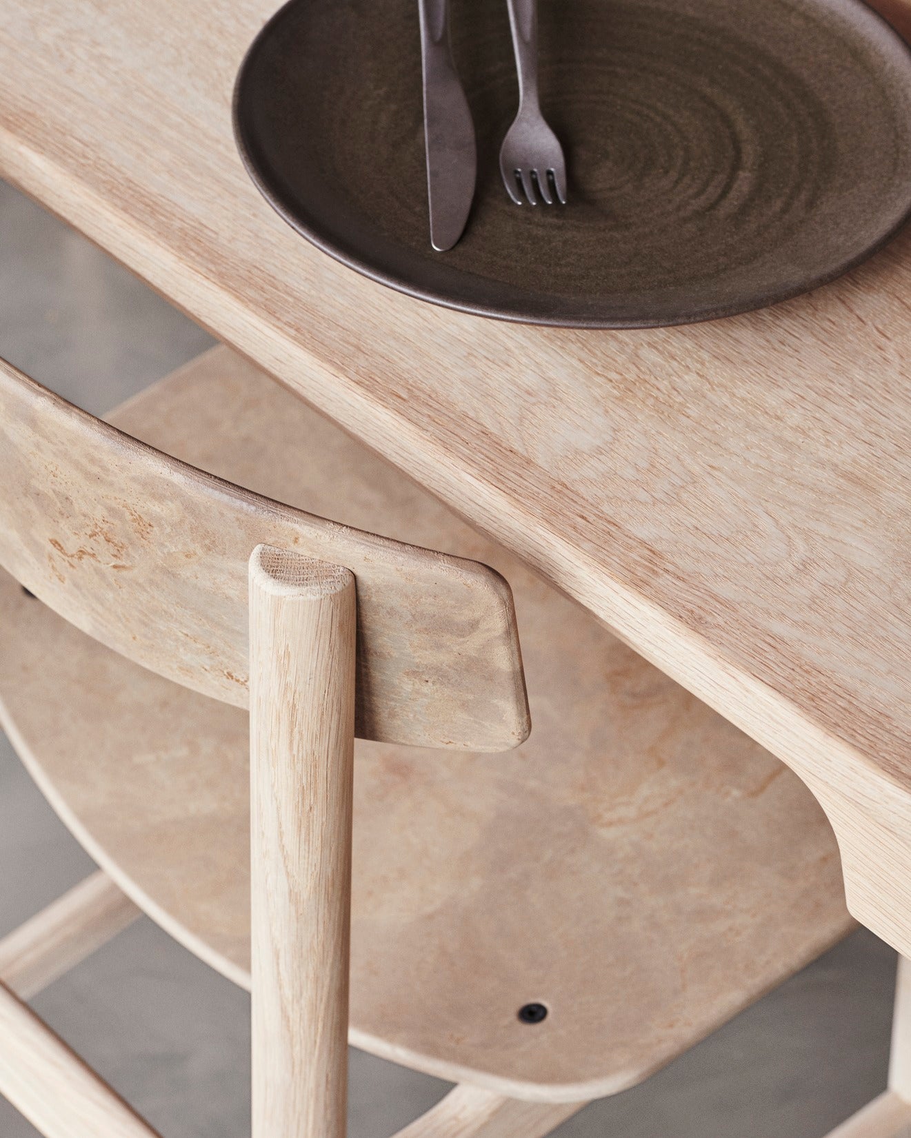 A closer look at the light coffee Conscious chair made with recycled material by Mater, top angle view.
