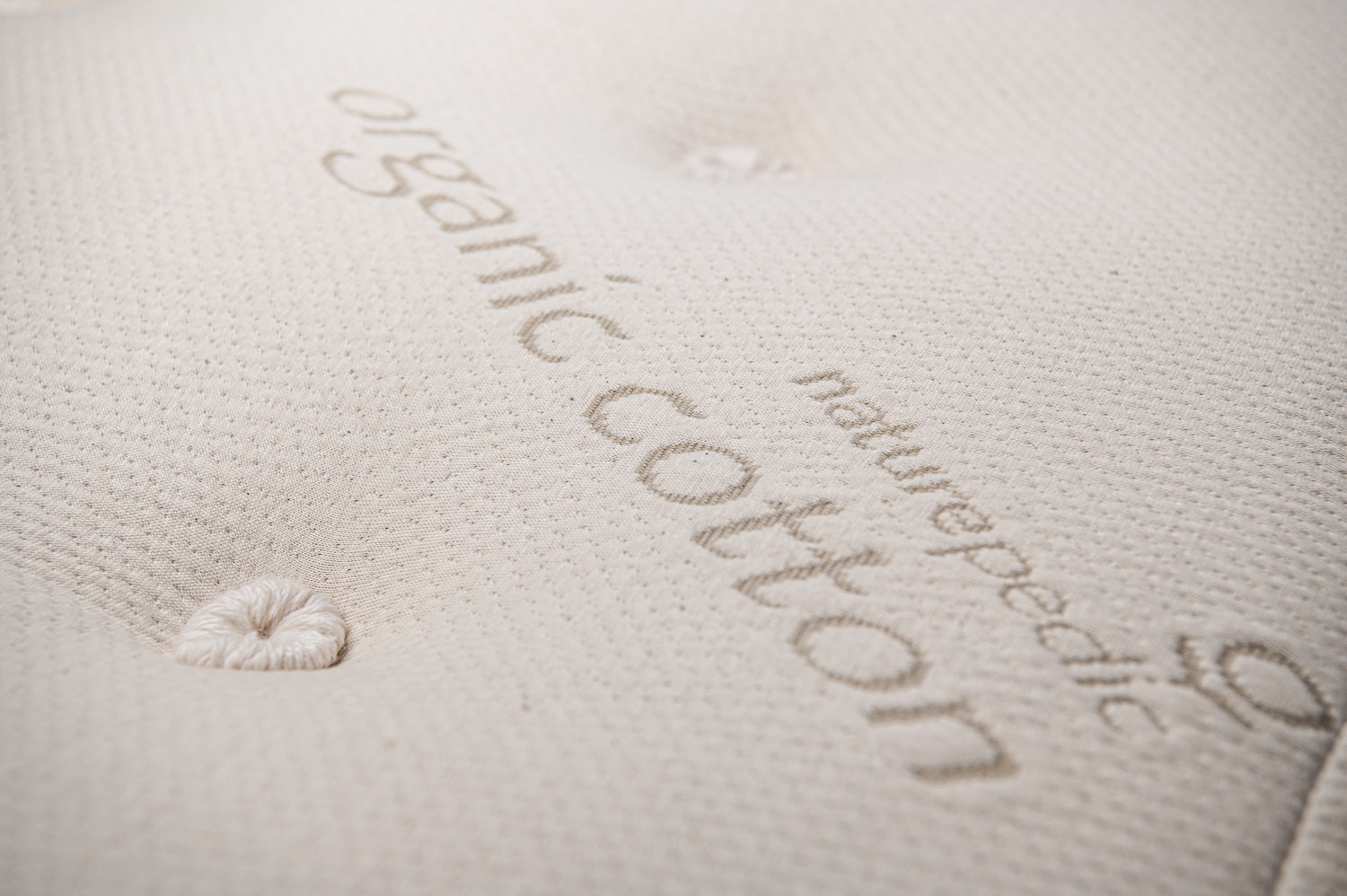 Naturepedic brand name and 'organic cotton' on a mattress top.
