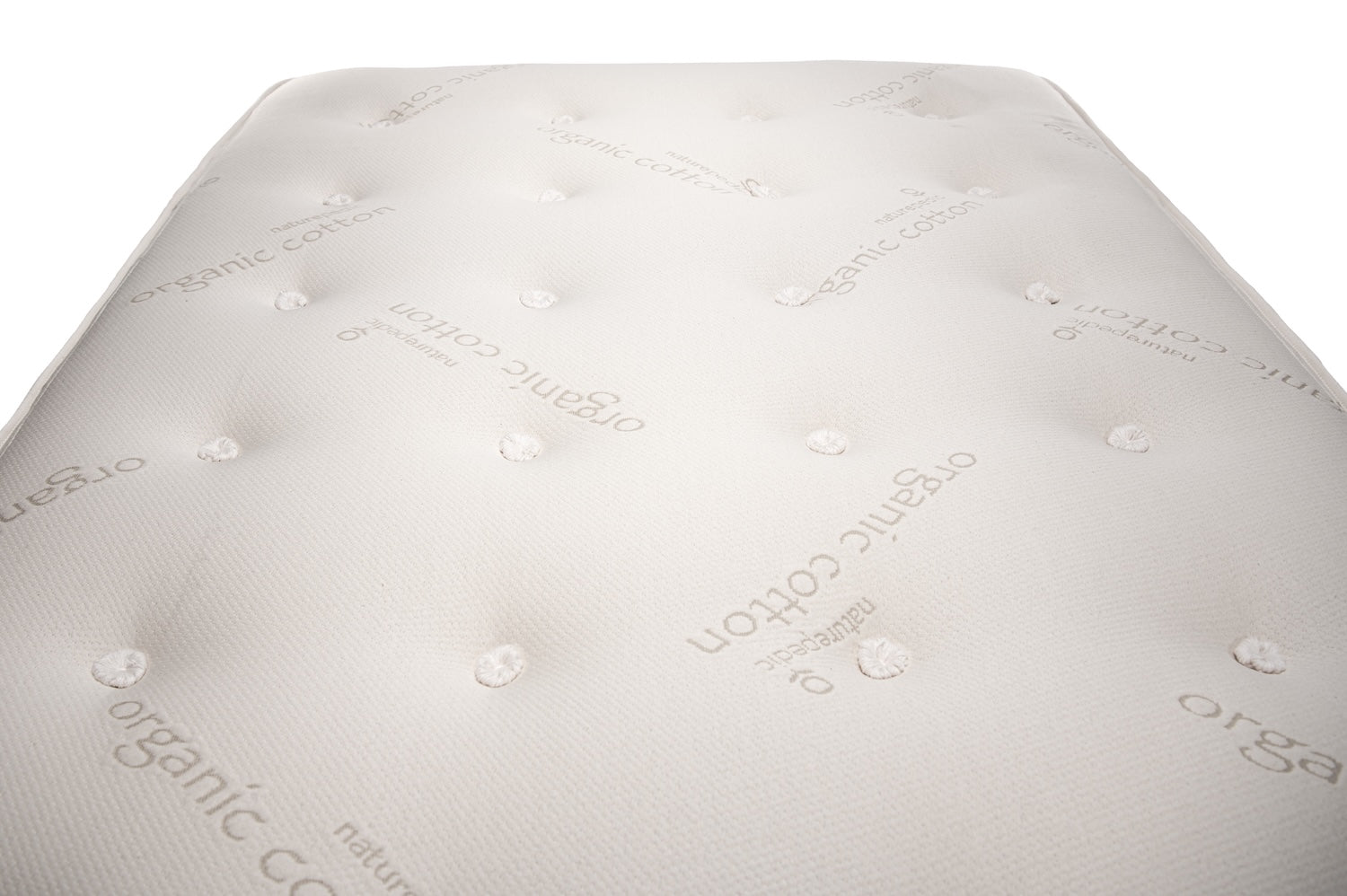 Close-up of a mattress top with 'organic cotton' branding on a white background