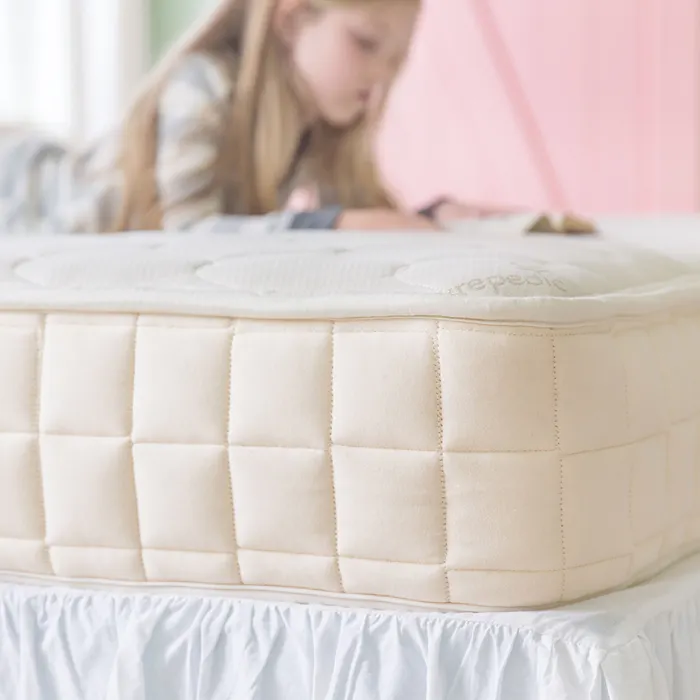 Kids non-toxic Mattress with a child reading in the background