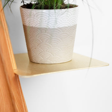 A two-tone design pot placed on the handcrafted Wallflower shelf made of recycled material, by Formr.